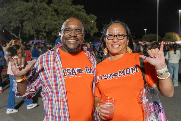 UTSA Parents in front of a row of booths at BestFest